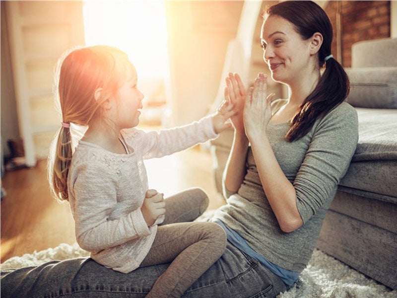 Mother playing with daughter