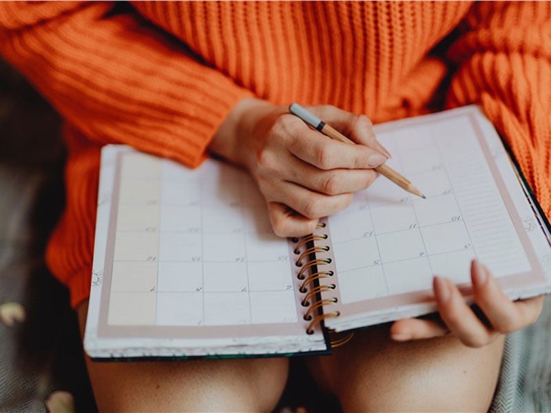 Women writing in dairy