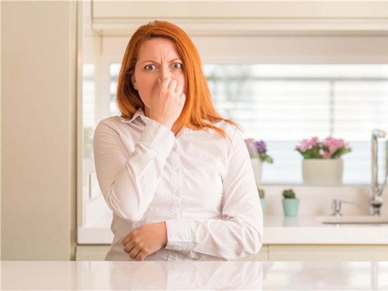 Girl holding her nose