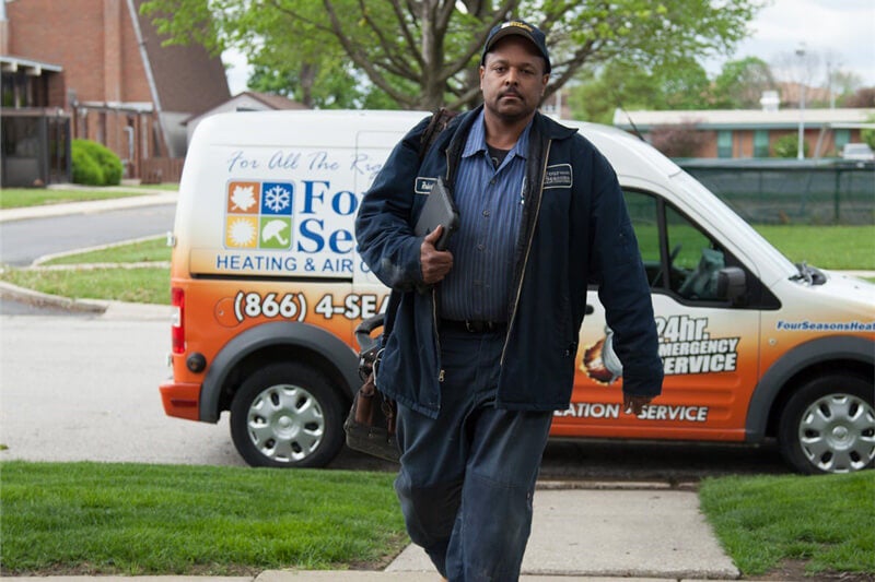 service technician walking to house from van