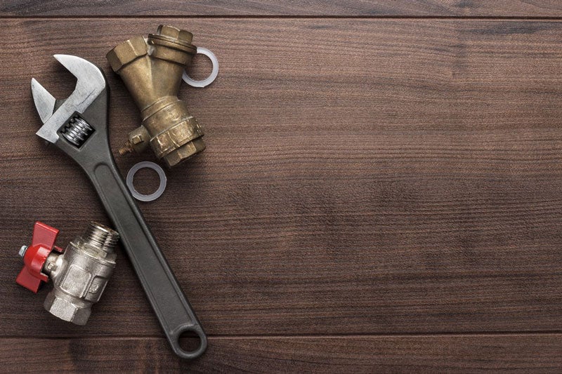 plumbing tools laid on wood