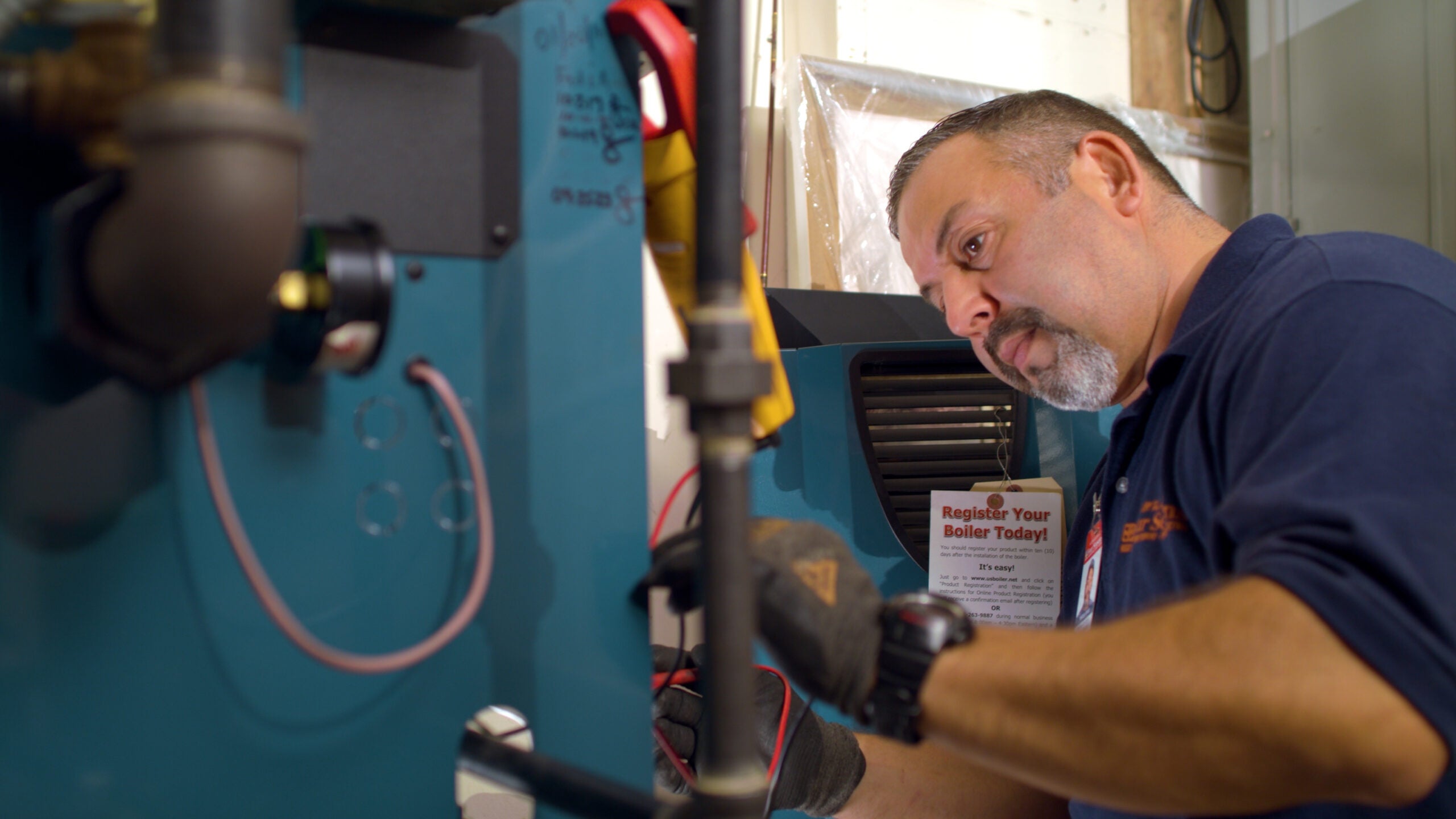 HVAC technician performing a preventive maintenance inspection and cleaning on a residential heating unit.