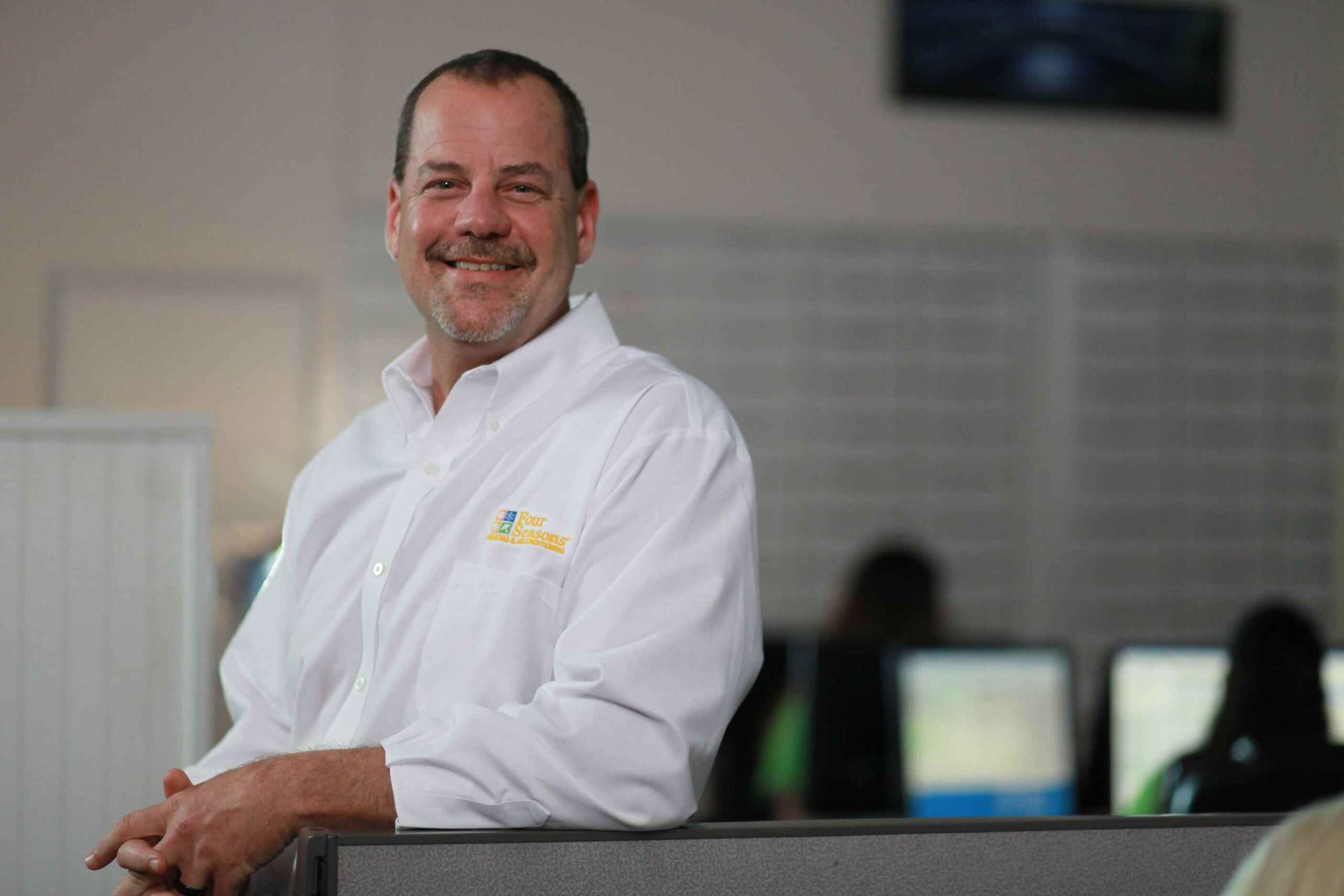 Jeff Vida Smiling in the Four Seasons Office