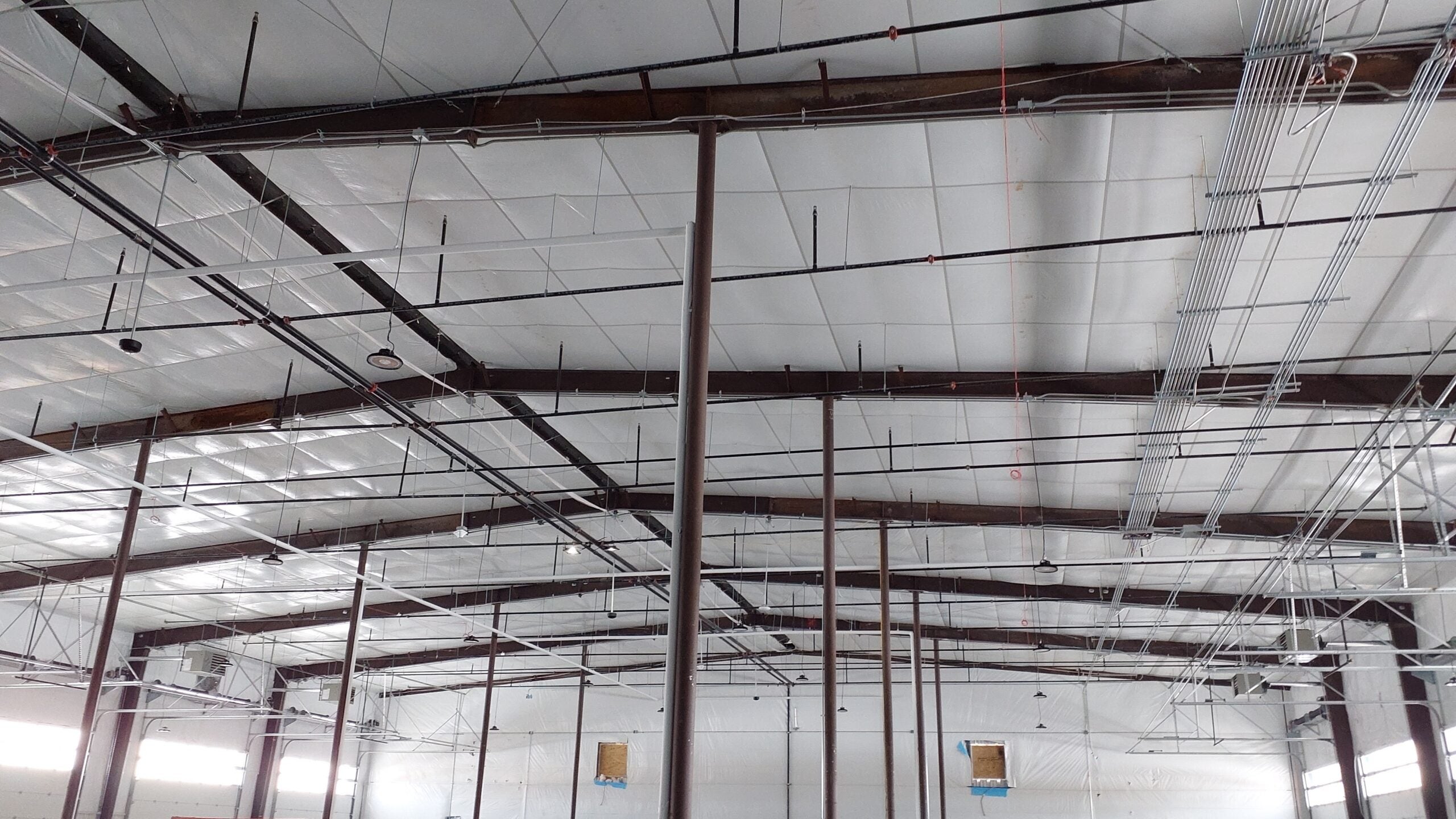 warehouse interior with newly installed commercial lighting